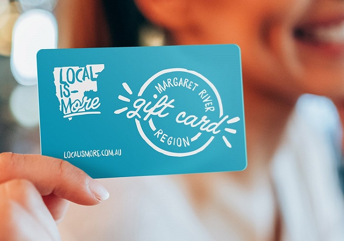 Photo of a hand holding a Local-Is-More Margaret River Region gift card.