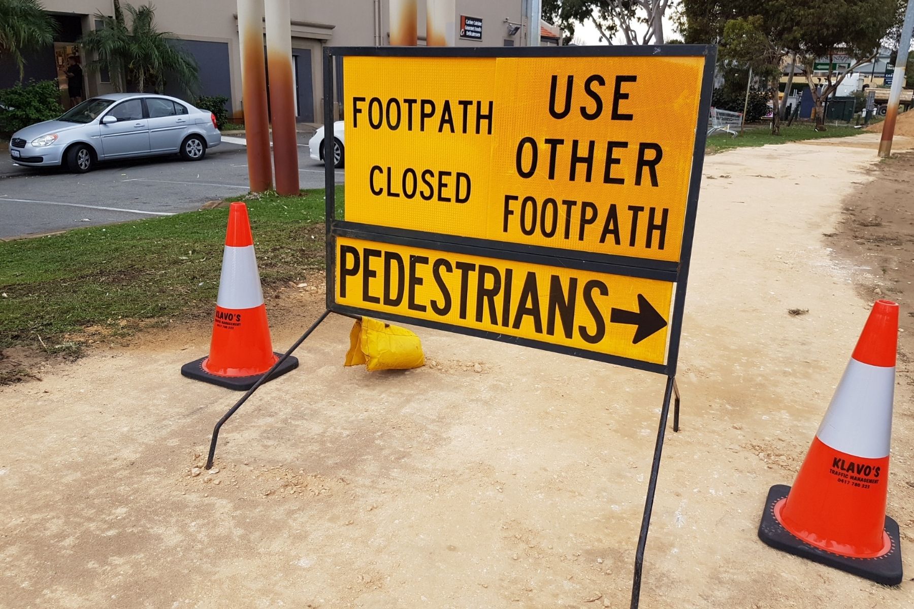 Photo of construction sign advising pedestrians to use the other foot path.